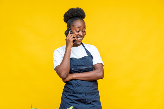 Excited Female African Chef Making A Phone Call