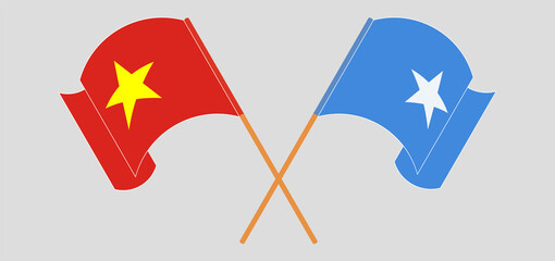 Crossed and waving flags of Vietnam and Somalia