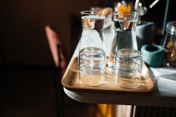 Four glass cups on the bar counter with serving accessories.