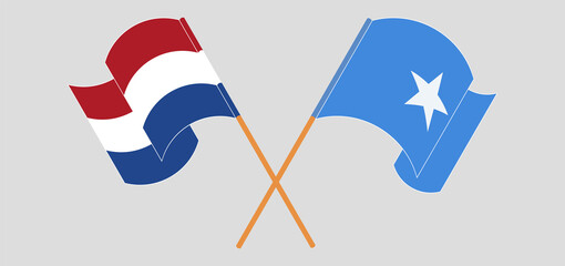 Crossed and waving flags of the Netherlands and Somalia