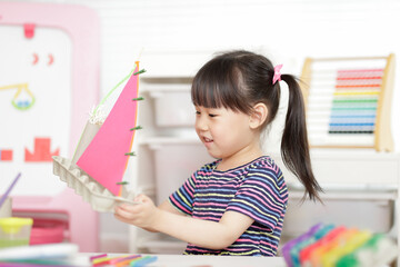 young girl hand making boat craft using egg cartons  for homeschooling