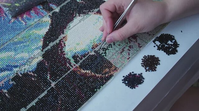 Diamond mosaic collection accelerated process. Fast video gluing crystals on the basis of the adhesive pattern. timelapse