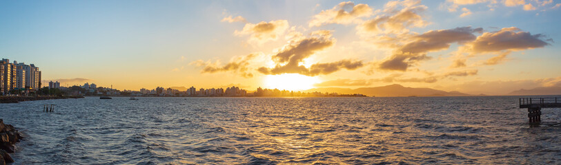 Panoramic of the waterfront with the pier and buildings at sunset in the city of Florianópolis, Santa Catarina, Brazil