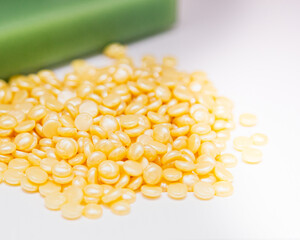 Golden Wax Beans for Hair Removal.  Hot Wax Beads in cosmetology. Group of yellow items.