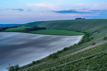 Fototapeta premium view of the Southern edge of Pewsey Vale with copse woodland in the up-faulted valley near Pewsey, Wiltshire, North Wessex Downs AONB