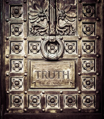 door to the truth emblazoned in bronze and gold