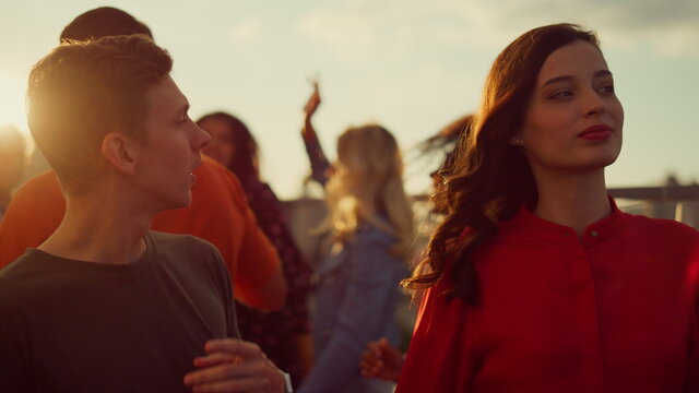 Cheerful couple hanging out at party. Young people partying in urban background
