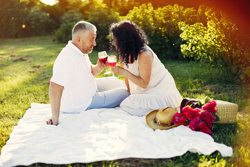 Naklejka premium Beautiful adult couple spend time in a summer field