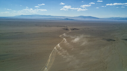 cars driving in the desert from above