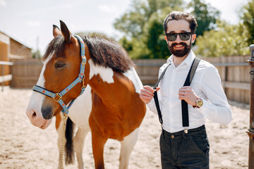 Fototapeta premium Handsme man standing in a ranch