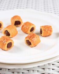 Nastar Gulung is Special Rolled Pineapple Tart Popular Baked for Ied Mubarak. Served on White Plate