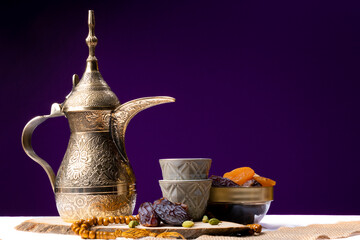 Eid and Ramadan set with Arabian coffee and dates set in dark background. Festive greeting card, an...