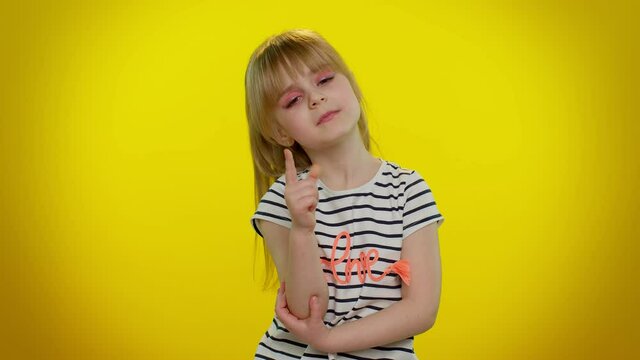 Need to think. Doubting pensive little blonde teen child kid girl pondering and imagining in mind, wondering difficult solution, feeling confused, not sure about choice on yellow studio background