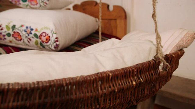 Vintage empty wooden cradle from the 19th century. A sense of antiquity.