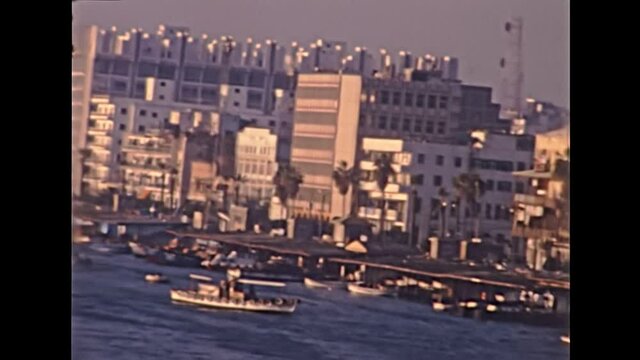 Port Said skyline in Egypt with local boats in Mediterranean sea. Historical archival of Egypt in 1980s with egyptian arab buildings. Historical archival of Egypt in 1987.