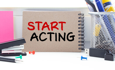 Start Acting - concept of text on business card. Closeup of a personal agenda on blue background
