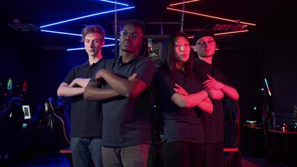 To represent the teams at the grand esports tournament, multinational guys and a girl look into the camera and fold their arms over their chests