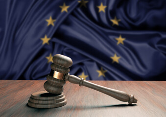 Judge gavel and blur European Union flag in the background. Law, legislation and justice concept