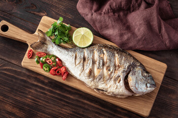 Grilled fish on the wooden board
