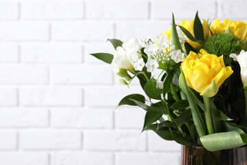 Beautiful bouquet with peony tulips near white brick wall, closeup. Space for text