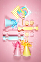 Birthday and party theme flatlay styled with party hats and bon bons. Blog hero header creative composition layout. Vertical styling.