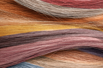 Strands of different color hair as background, closeup