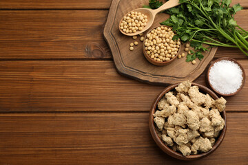 Flat lay composition with dehydrated soy meat on wooden table. Space for text