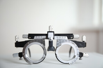 Trial frame on white table. Ophthalmologist tool
