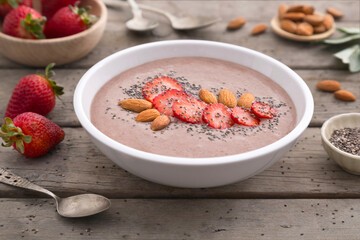 Quinoa smoothie with strawberry, almond and chia seeds on rustic table
