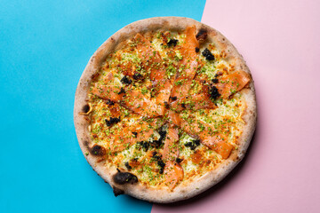 A whole smoked salmon pizza, oven baked gourmet pizza, directly above view