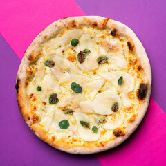 Whole round pizza with pear and gorgonzola cheese, gourmet pizza in bright background
