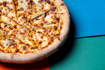 Close up of cheese pizza on bright modern colourful background, close up