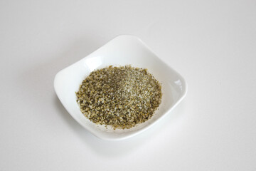 Herb salt on white plate.