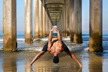 Yoga Male Afro-American Instructor in Wide Legged Forward Bend