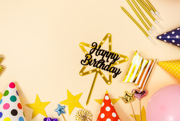 Background for happy birthday celebration or party. Group of colored balloons , confetti, candles, ribbons on beige pastel background. Mock up with copy space, place for text	