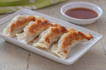 Fried dumplings Gyoza on plate and soy sauce.