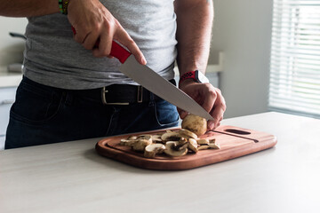 close-up shot of a man cutting mushrooms