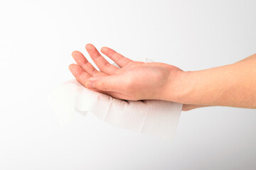A person who wipes hands with wet wipes on a white background