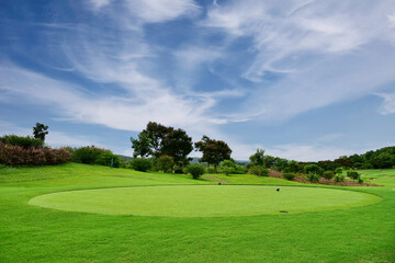 Beautiful view landscape in morning time green grass at golf course ,big trees, sand bunker and mist with sunlight rays background.