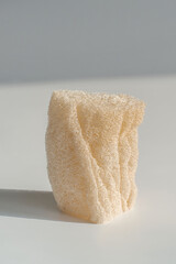Loofah natural sponge on the white background. - obrazy, fototapety, plakaty