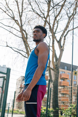 Young man standing on basketball court 