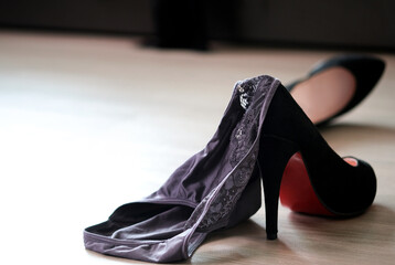 Women's sexy underwear Laying on the floor with black heels Bedroom background