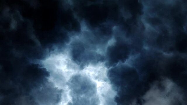 dark, moving cumulonimbus clouds in the blue sky, thunderstorms accompanied by flashes of lightning