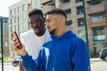 Two men looking at phone screen