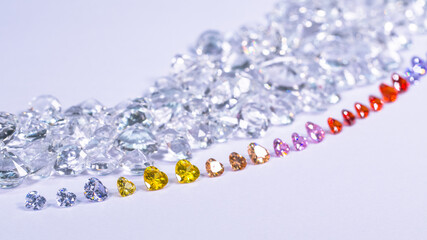colorful diamond in heart shape are placed in a row on white diamonds background,