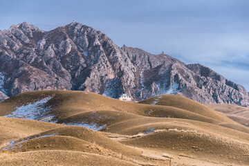 A Chinese building at the foot of the mountain
