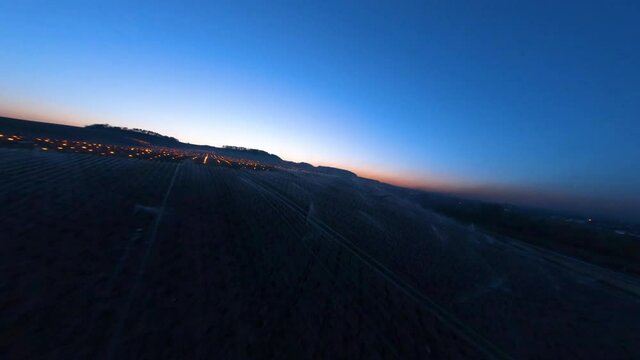 Fast DJI FPV Aerial over Candles burning to heat up the Vineyards and sprinkling of the buds in Chablis, France
