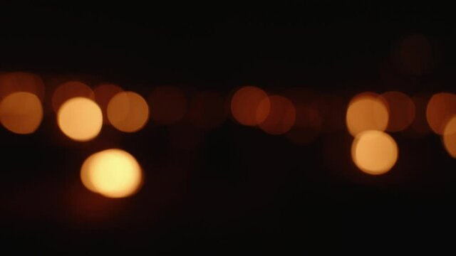Sparkling out of focus Candles burning to heat up the Vineyards in Chablis, France.