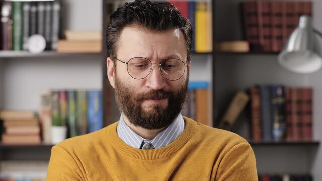 Man is at loss, bewilderment, surprise, misunderstanding, facepalm emotion. Embarrassed bearded male teacher or businessman with glasses looking at camera. Slow motion