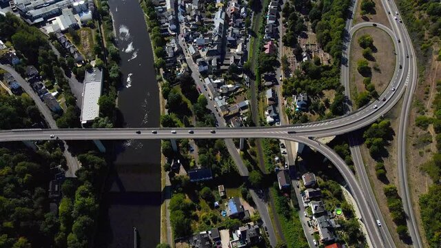 Rising aerial drone shot of cars driving on overpass over the Rhine River in Lahnstein, Germany.